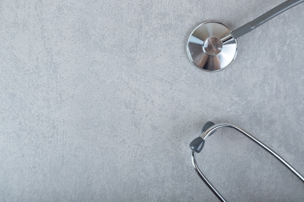 Black stethoscope isolated on gray surface