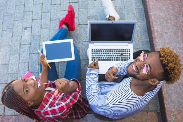 Black students posing with gadgets