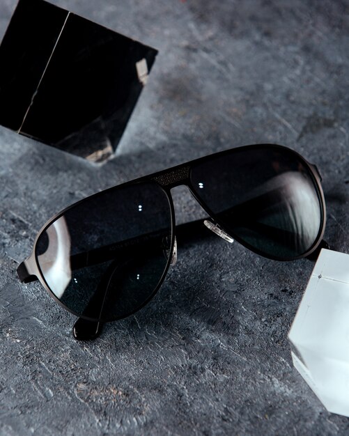 Black sunglasses on the grey surface