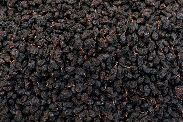 Black sweet raisins dried sweet grapes surface