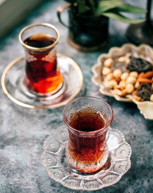 A black tea in armudu glass and nuts