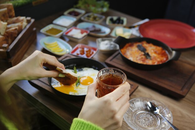 Black tea in glass and breakfast set close-up view