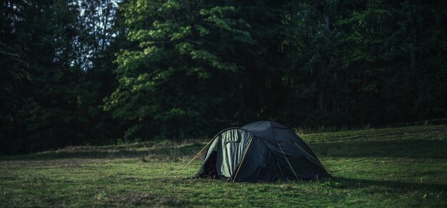 Black tent in the middle of a field