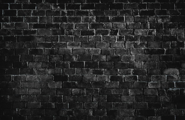 Free photo black textured brick wall background