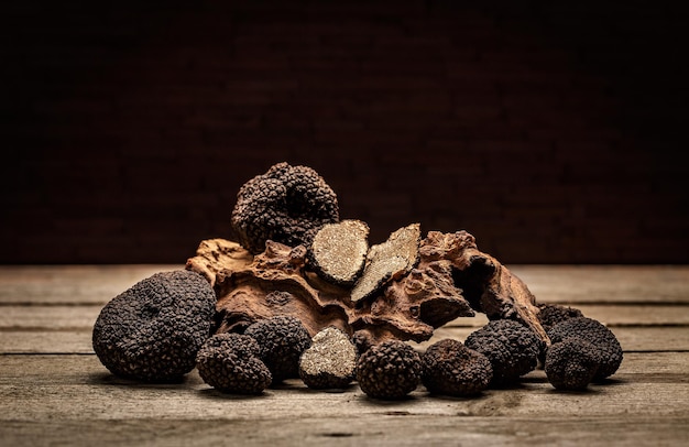 Black truffles mushrooms on rustic wooden table with free text space