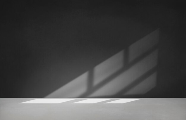 Black wall in an empty room with concrete floor