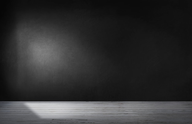 Black wall in an empty room with concrete floor