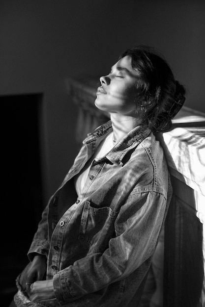 Free photo black and white analog portrait of woman posing indoors