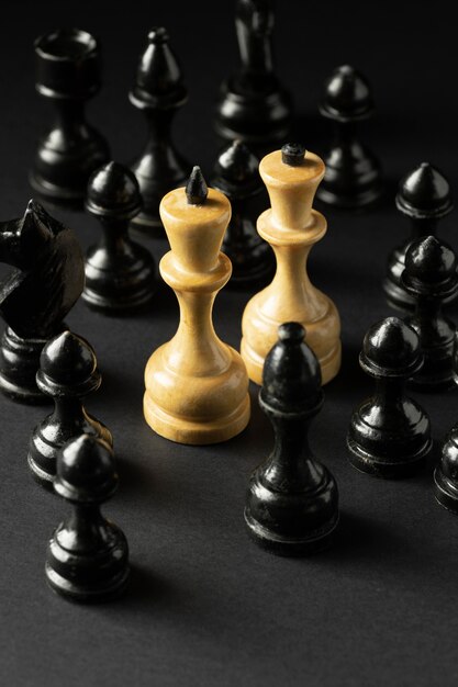 Black and white chess pieces on black background