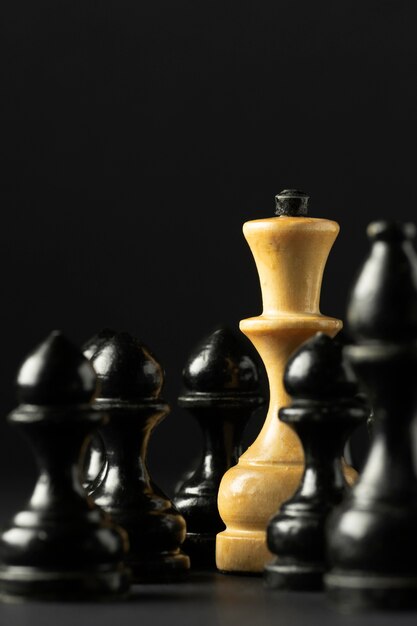 Black and white chess pieces on black background