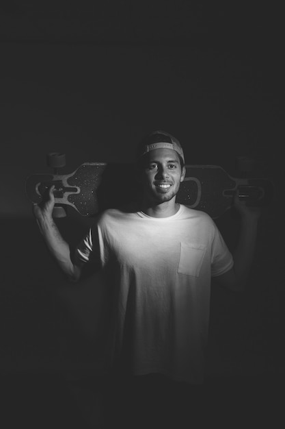 Black and white effect of young man with longboard