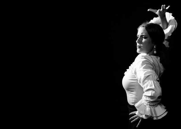 Black and white flamenca with arm up and copy space