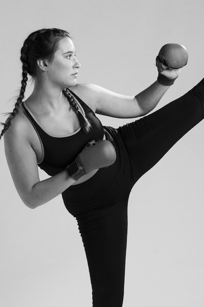 Free photo black and white karate woman kicking