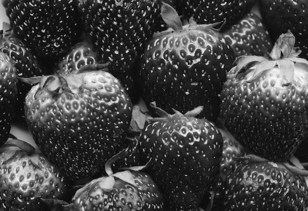 Free photo black and white macro of yummy strawberries background