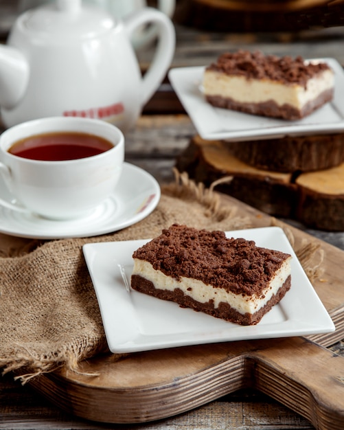 Black and white pastry slice served with black tea