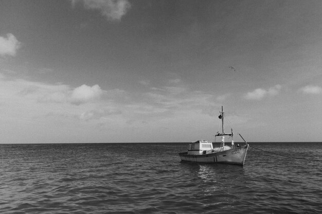 Black and white photo of a large boat floating in the open sea