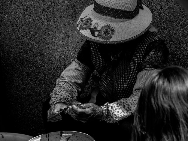 Black and white photo of old woman wearing hat