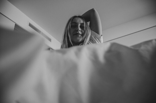 Black and white photo of woman in bed