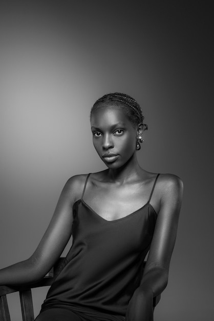 Free photo black and white portrait of woman on chair in old hollywood glamour style