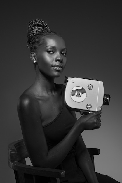 Black and white portrait of woman with camera in old hollywood glamour style