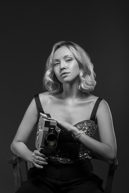 Черно-белый портрет женщины с камерой в стиле старого голливудского гламура