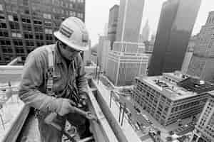 Free photo black and white scene showcasing the life of construction workers on the site