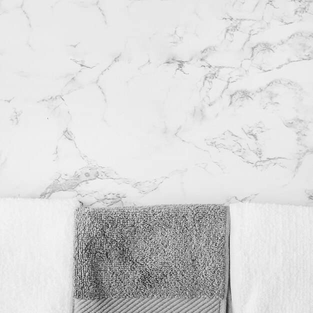 Black and white towels on marble backdrop