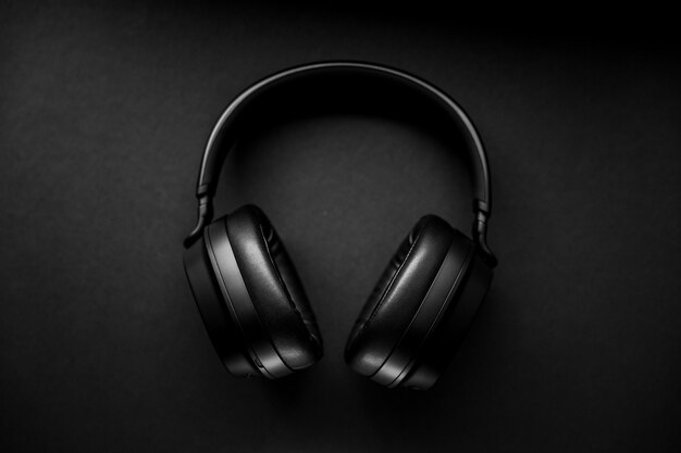 Black wireless headphones on black surface