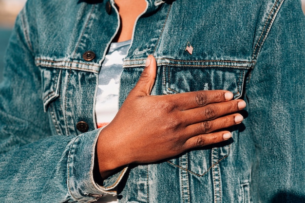 Black woman holding hand on heart