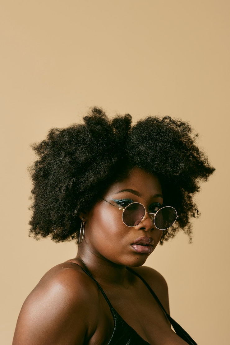 Free Photo black woman posing in studio side view