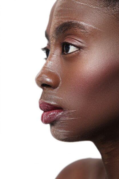 Black woman profile closeup, painted face