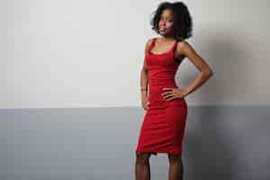 Free photo black woman in red dress showing beauty body