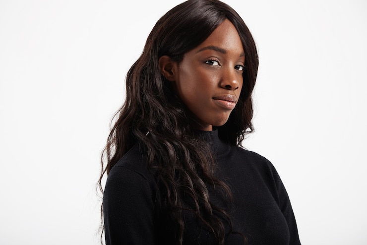 Free Photo black woman's portrait wavy hair black clothes