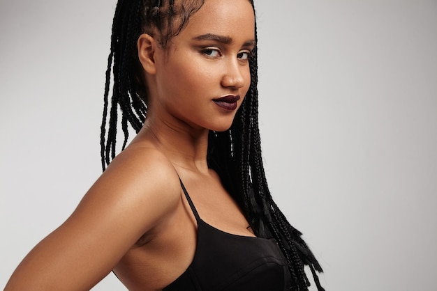 Black woman's portrait with braids watching at camera