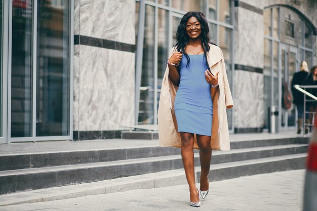 Black woman standing in a autumn city