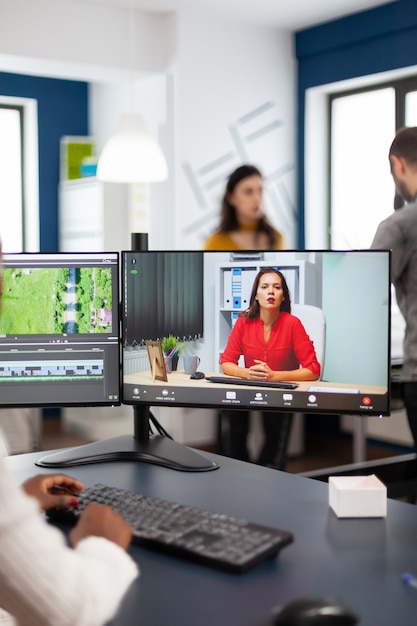 Black woman videographer in web online conference with project manager