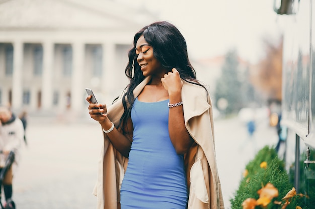 Black woman walking in a autumn city