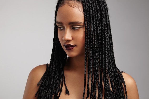 Black woman watching aside showing her braids