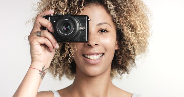 Black woman with curly afro hiar and freckles portrait