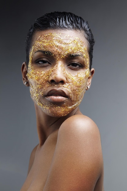 Black woman with a golden mask