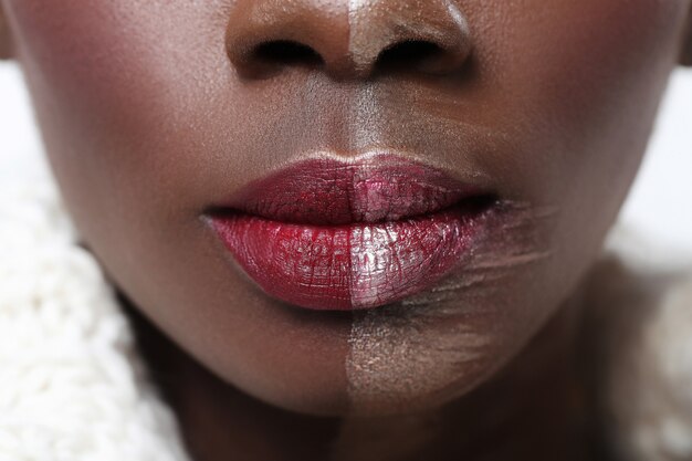 Black woman with half face on makeup, beauty concept