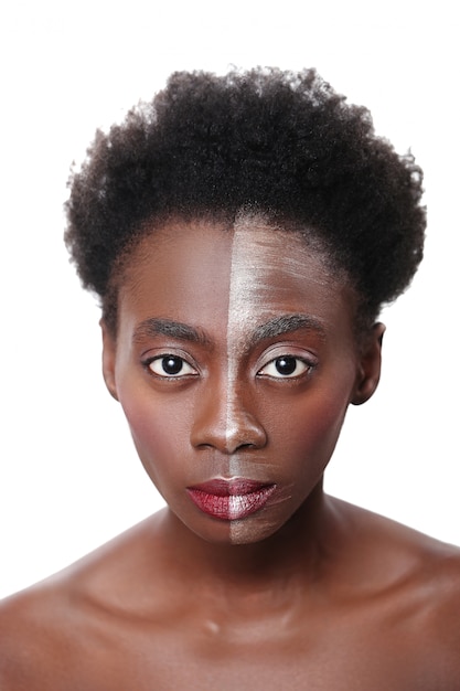 Black woman with half face on makeup, beauty concept