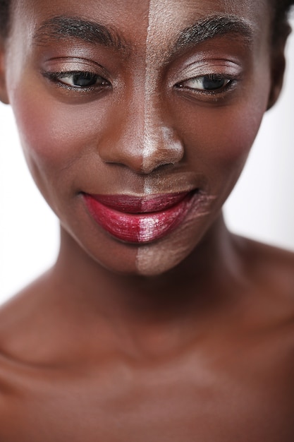 Black woman with half face on makeup, beauty concept