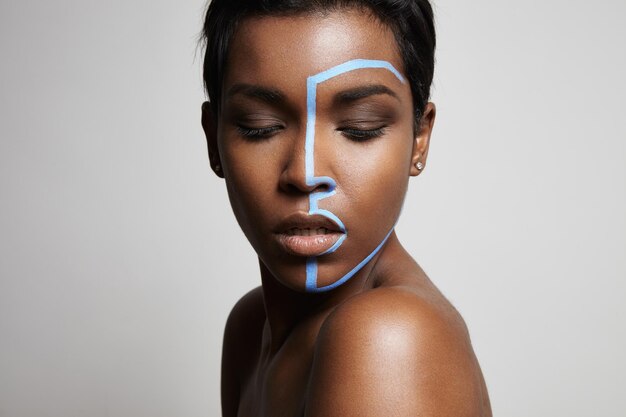 Free photo black woman with a line on her face