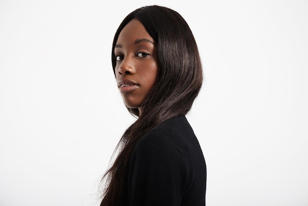 Black woman with long hair watching at camera