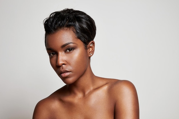 Black woman with a short hair looking at camera