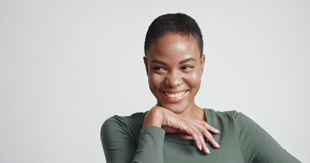 Free photo black woman with a short haircut in studio shootsmiling and wearing dress