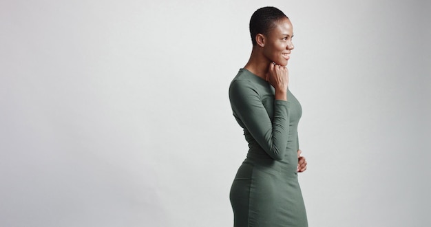 Free photo black woman with a short haircut in studio shootsmiling and wearing dress