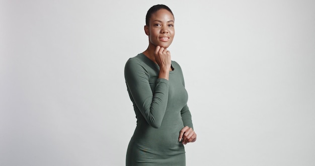 Free photo black woman with a short haircut in studio shootsmiling and wearing dress