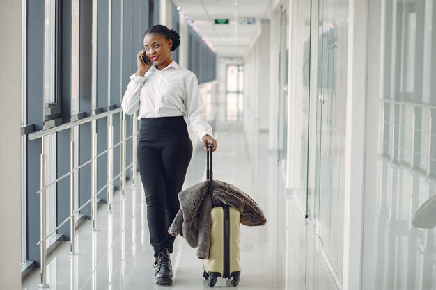 Black woman with suitcase at the airport